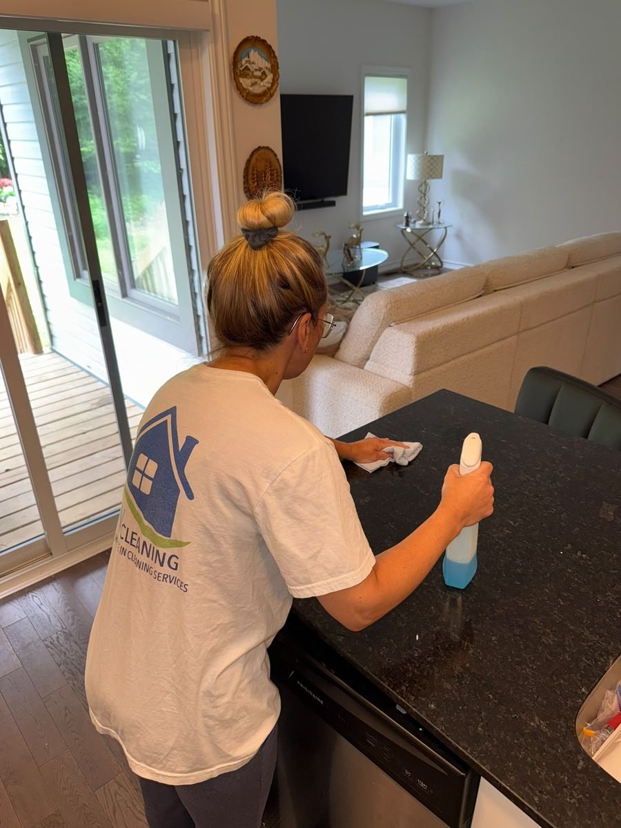 SW Cleaning crew member cleaning a kitchen counter